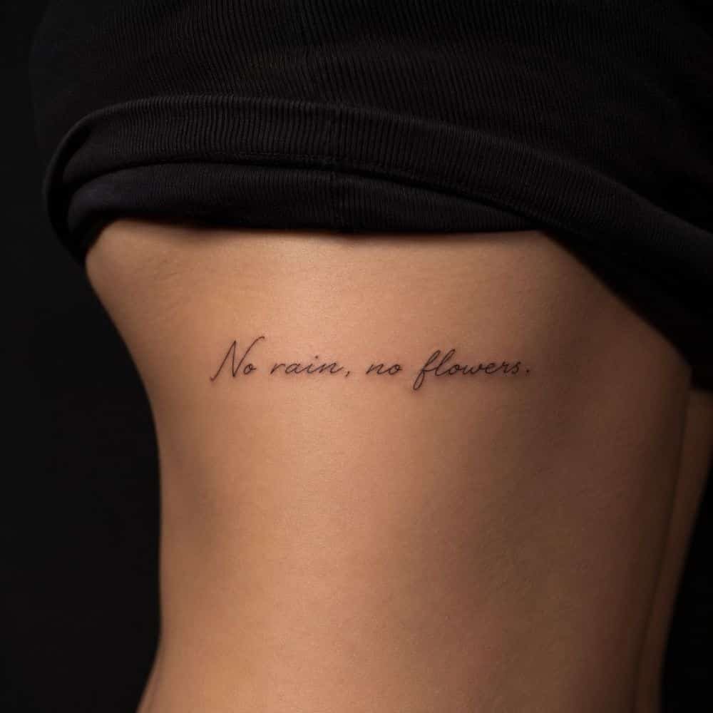 Tatuaje de lettering con una frase en caligrafía negra